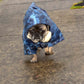 A fawn male pug is wearing a Blue Camouflage Dog Raincoat